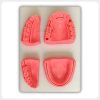 Four silicone dental suture modules fixed on white base
